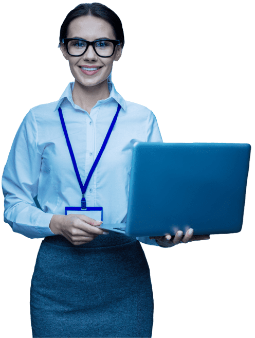 A woman in glasses, wearing a white shirt and blue lanyard, holding a laptop and smiling at the camera.